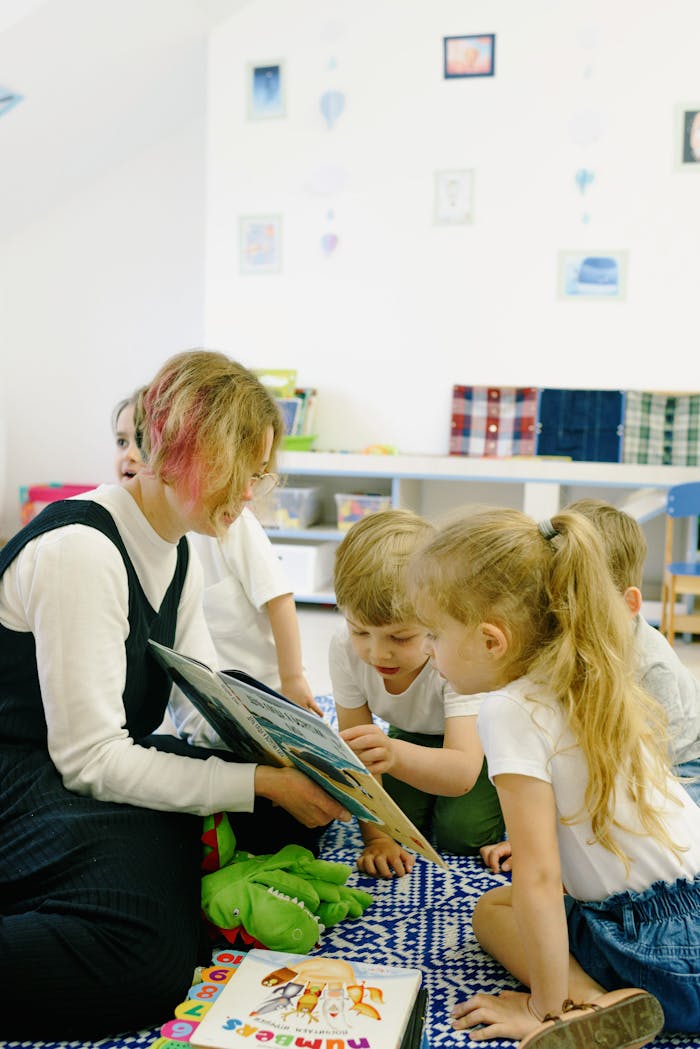 Children in the School Reading a Book with a Teacher